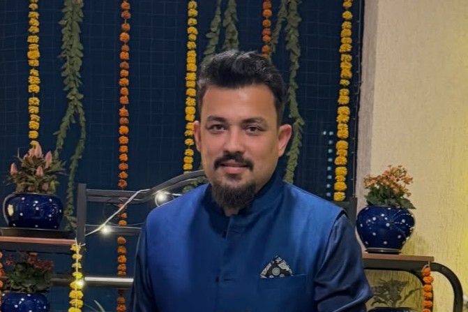 Mourjo Chatterjee seated during a production setting